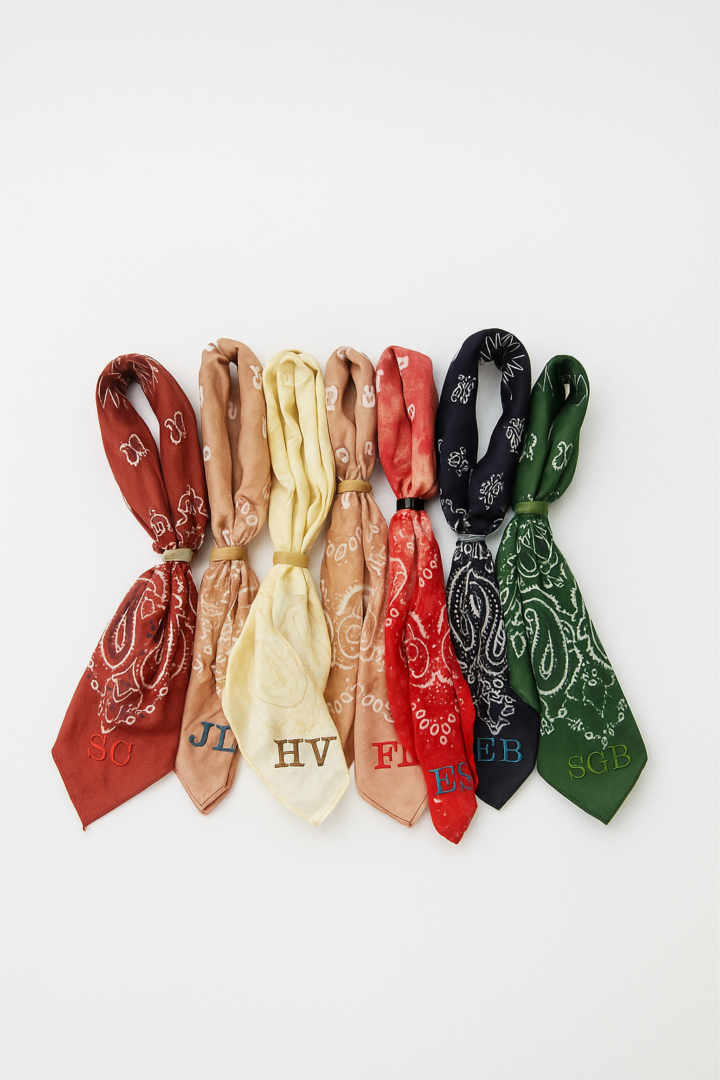 Set of bandanas in various colors with different patterns and text on a white background