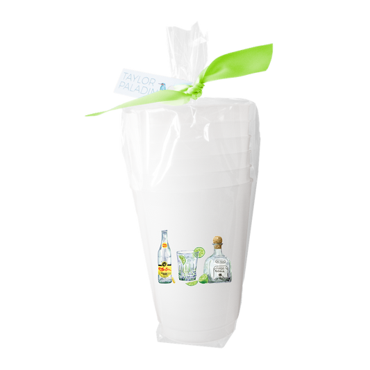 White gift bag with a green ribbon featuring images of bottles and glasses on a white background