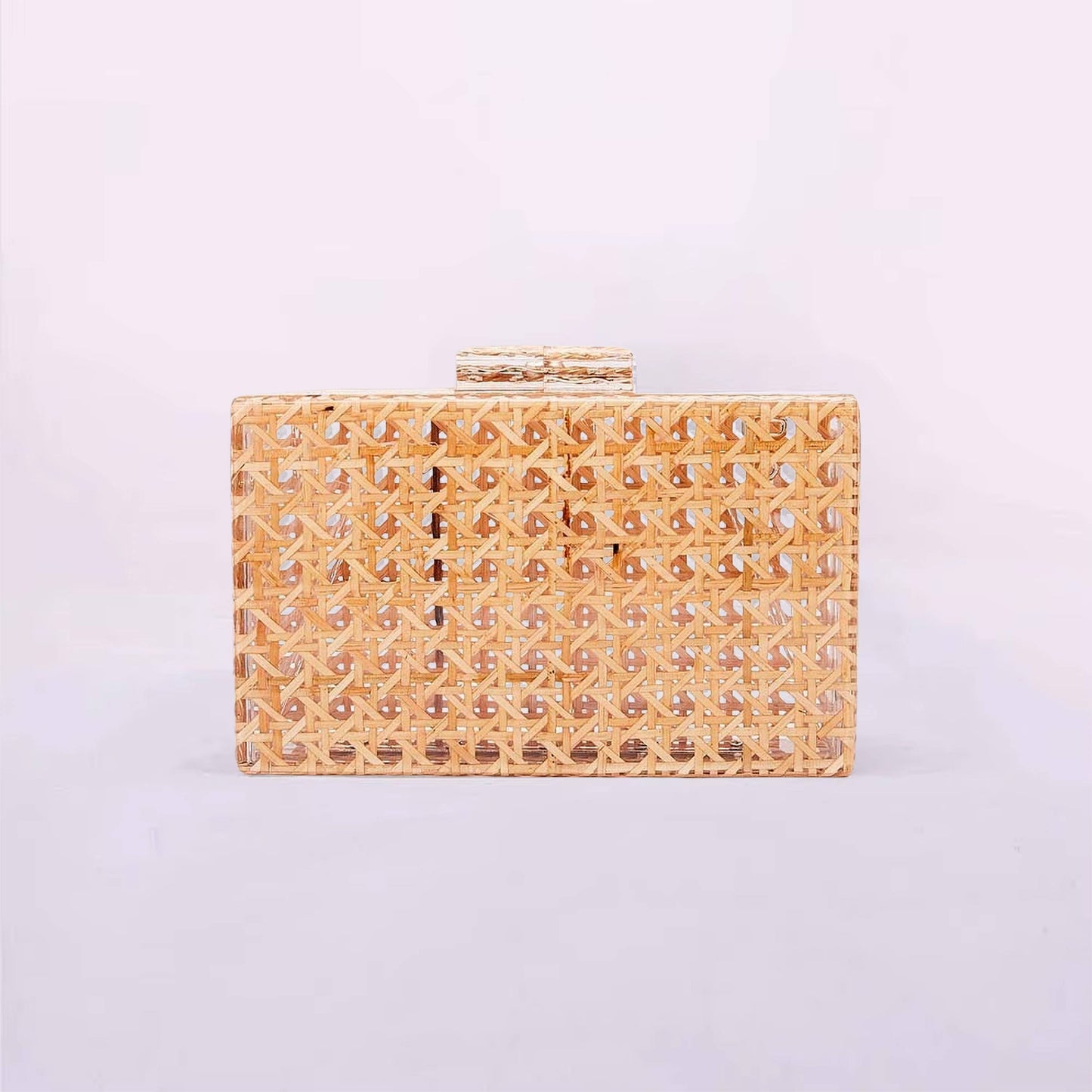 Gold clutch bag with intricate design on a light purple background