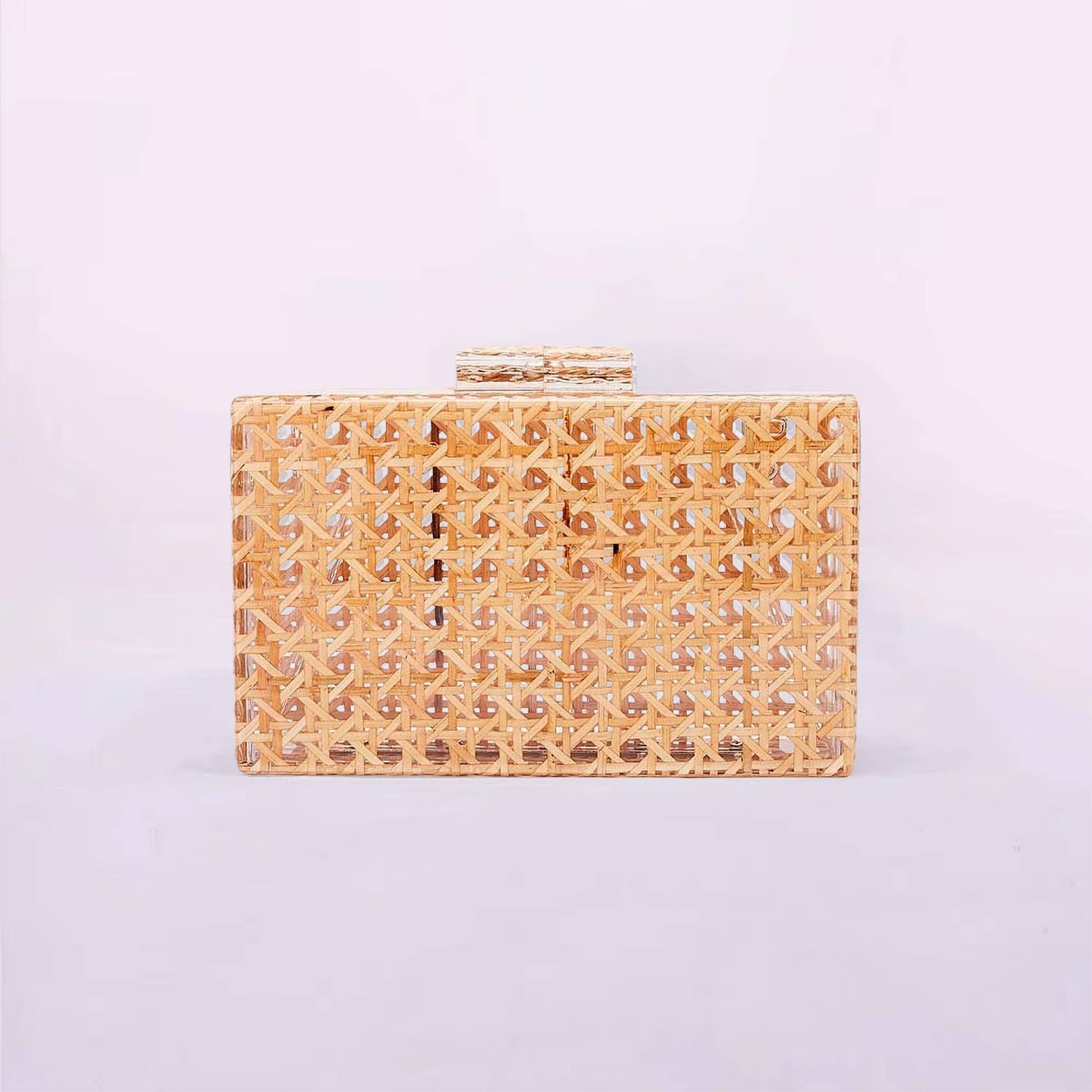 Gold clutch bag with intricate design on a light purple background